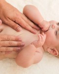 masseur doing massage little baby